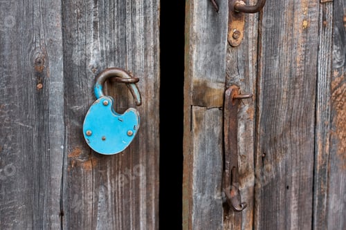 Preview: Blue old rusty unlocked padlock on wooden door
