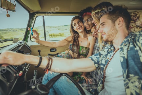 Preview: Happy friends driving a vintage minivan
