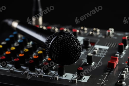 Preview: Professional mixing console with microphone on black background, closeup