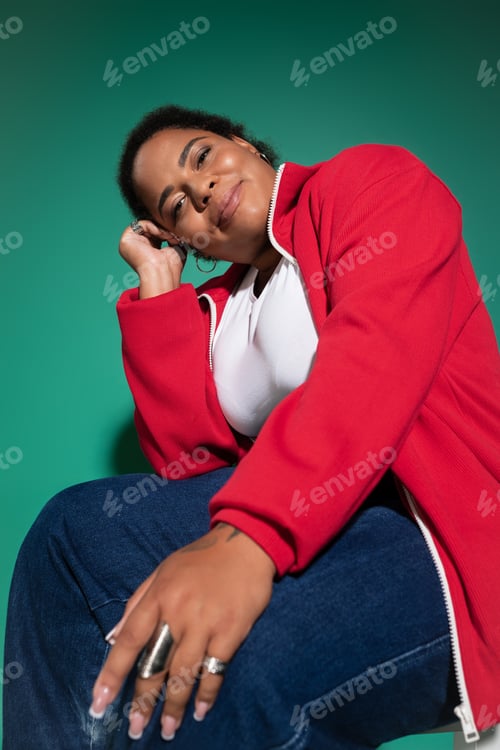 Preview: Stylish plus size african american woman showcases trendy autumn outfit in studio