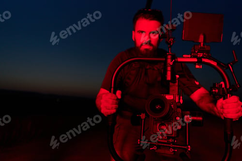Preview: Nighttime Capture: Professional Videographer Films Athletes Running in Red-Lit Darkness