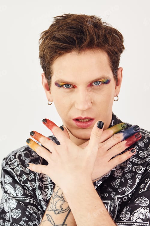 Preview: Young gay man is standing in the studio and posing for a camera