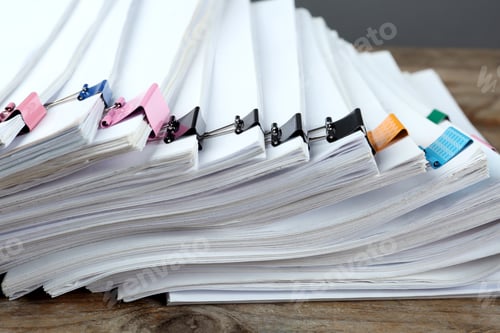 Preview: Stack of documents with colorful binder clips on wooden table, closeup