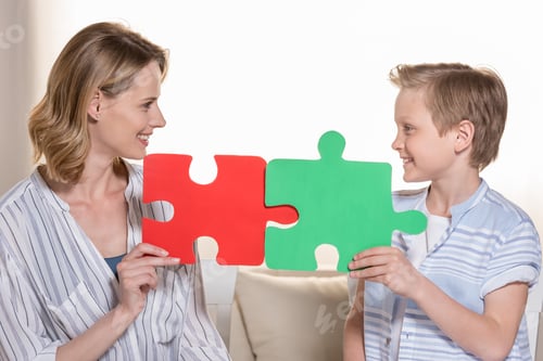 Preview: Mother with son holding puzzle pieces