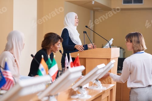 Preview: Young contemporary female delegate in hijab and suit