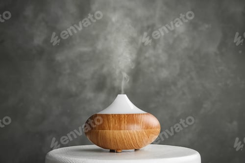 Preview: Modern essential oil diffuser on white table against grey background