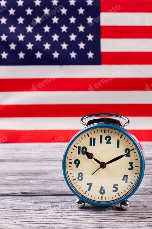 Preview: Alarm clock on USA flag background.