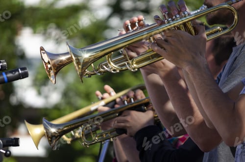 Preview: Selective focus shot of musicians playing on trumpets