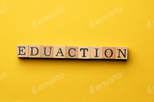 Preview: a yellow warm background without shadows wooden cubes with black letters laid out word education