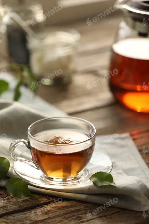 Preview: Tasty tea in cup on wooden table, closeup
