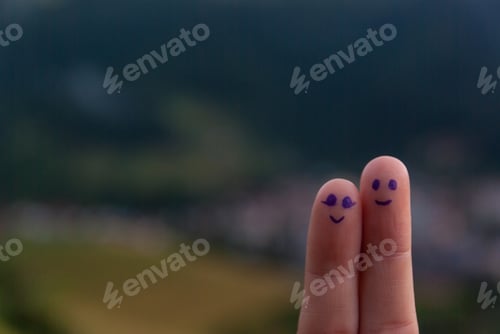 Preview: couple face painted at finger on landscape background,happy couple concept