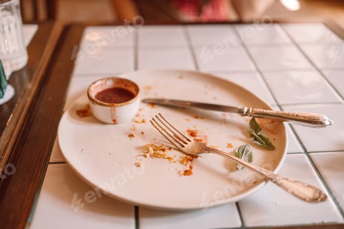 Preview: Empty dirty dish after breakfast with sauce and dessert fork.