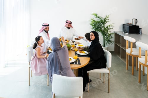 Preview: Happy arab family wearing saudi arabia clothing at home