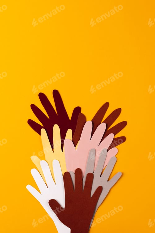 Preview: Paper cut out of multi coloured hands with copy space on orange background