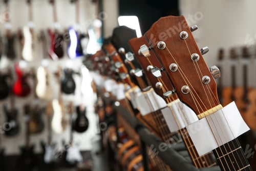 Preview: Row of different guitars in music store, closeup