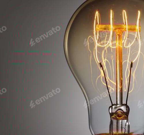Preview: Illuminated Vintage Filament Bulb Against Gray Background