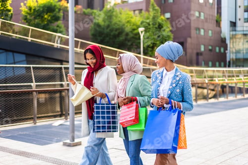 Preview: Beautiful muslim girl wearing hijab bonding outdoors