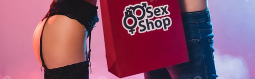 Preview: horizontal crop of sexy woman and man near shopping bag with sex shop lettering on pink
