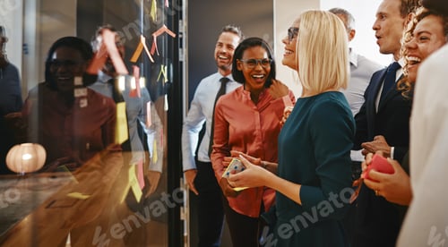 Preview: Smiling businesspeople standing in an office brainstorming with sticky notes