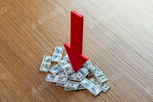 Preview: Red downward arrow pointing at piles of US dollar bills on wooden surface.