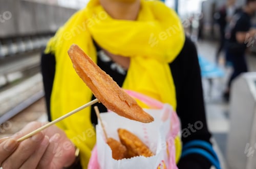 Preview: Asian Woman Eat Taiwanese Sweet Potato Fries In A City
