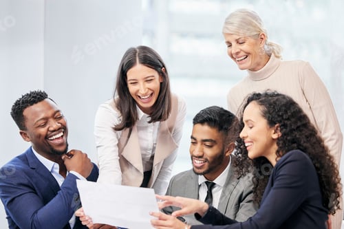 Preview: Cheerful Colleagues Laughing at Documents During Business Meeting
