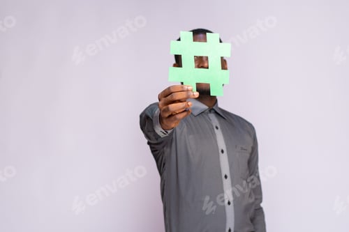 Preview: african businessman holding a hash tag symbol