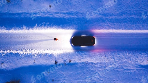 Preview: Person standing front automobile which lighting the way