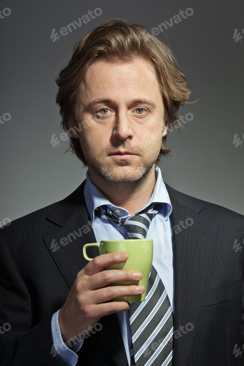 Preview: Studio Portrait Of Serious Young Business Man Holding Cup Of Coffee. Power. Boss. Having A Break.