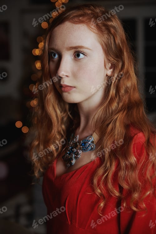 Preview: Redhead teenager in a red dress and an ornate necklace