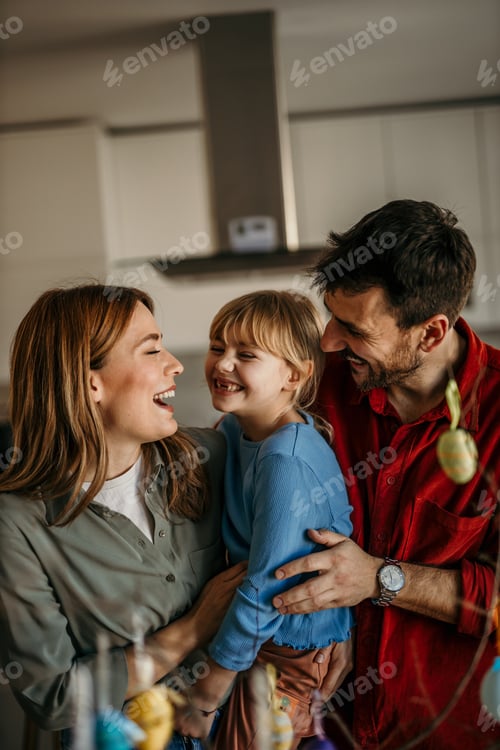 Preview: Happy family laughing together in a modern home