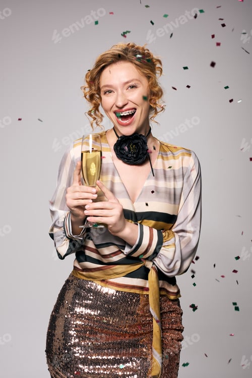 Preview: A young woman joyfully unwraps gifts while celebrating a festive occasion in a bright space
