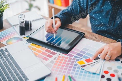 Preview: Graphic designer architects who work with laptops and color comparison tables for design work.