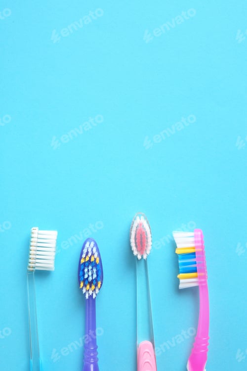 Preview: Flat lay composition with manual toothbrushes on color background