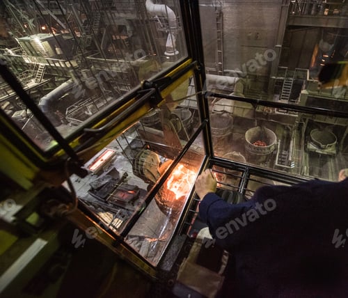 Preview: Worker operates in the cabin of a cargo crane at the steel mill