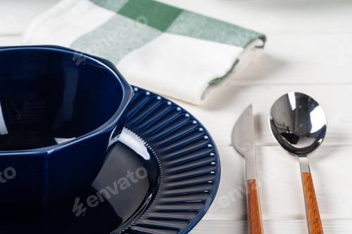 Preview: Classic blue ceramic tableware on checkered tablecloth