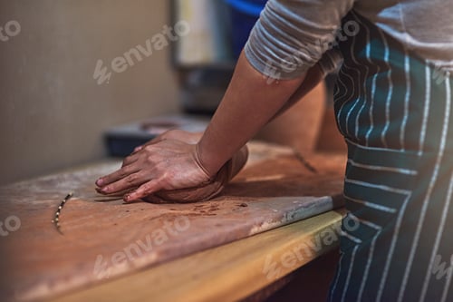 Preview: Mould your creativity. Closeup shot of a ceramic artist working on her pottery in a workshop.