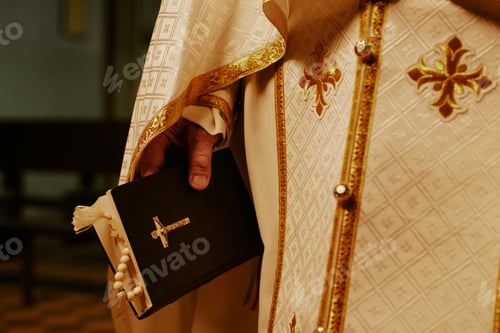Preview: Unrecognizable Priest Holding Bible Book