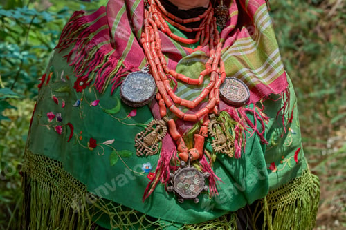 Preview: Close-up shot of a Maragato elderly woman in a traditional green Castilla y Leon costume and jewelry