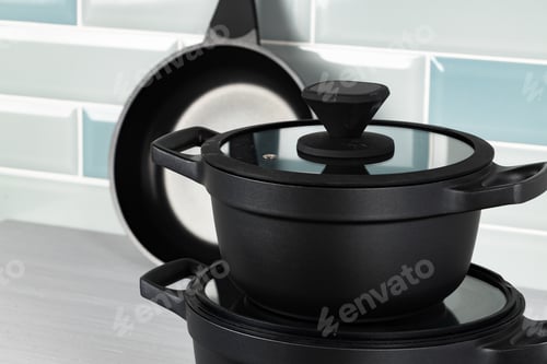 Preview: Set of black cookware on kitchen counter