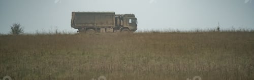 Preview: Military truck moving in a field