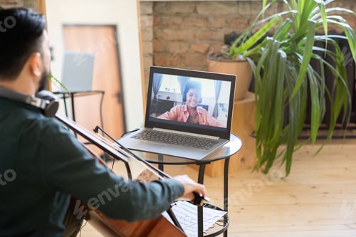 Preview: Happy schoolboy on laptop screen looking at his music teacher