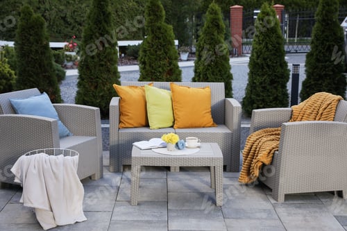Preview: Beautiful rattan garden furniture, soft pillows and different decor elements outdoors