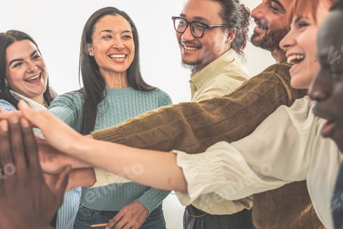 Preview: Group of happy coworkers holding hands encouraging each other before meeting