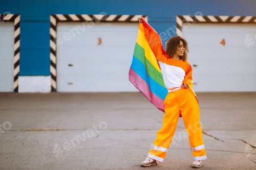 Preview: American lesbian woman holding LGBT rainbow flag. concept of happiness, love for same-sex couples.