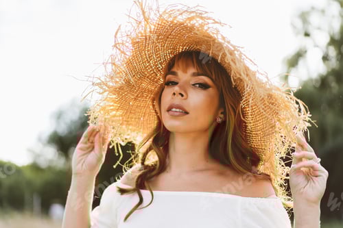 Preview: Woman in Straw Hat Poses Outdoors