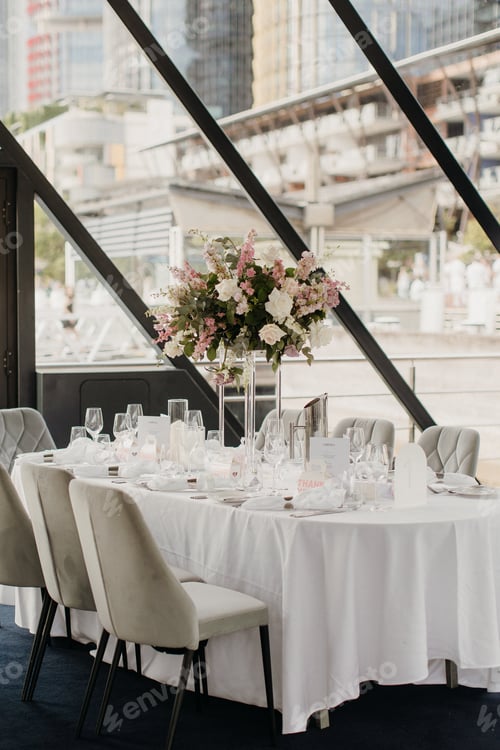 Preview: Close-up of an elegant table setting with vase and silverware