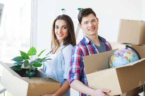 Preview: Happy young couple unpacking or packing boxes and moving into a new home