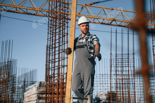 Preview: Communicating with other people. Man is working on the construction site at daytime