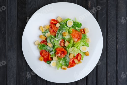 Preview: Top view of salad with quail egg, salmon fillet and vegetables with cheese